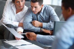 Portrait of a real estate agent consulting a mature couple at office